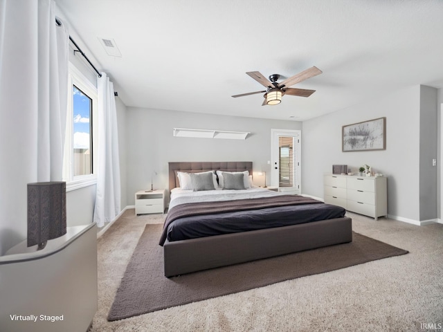 bedroom featuring multiple windows, carpet flooring, and visible vents