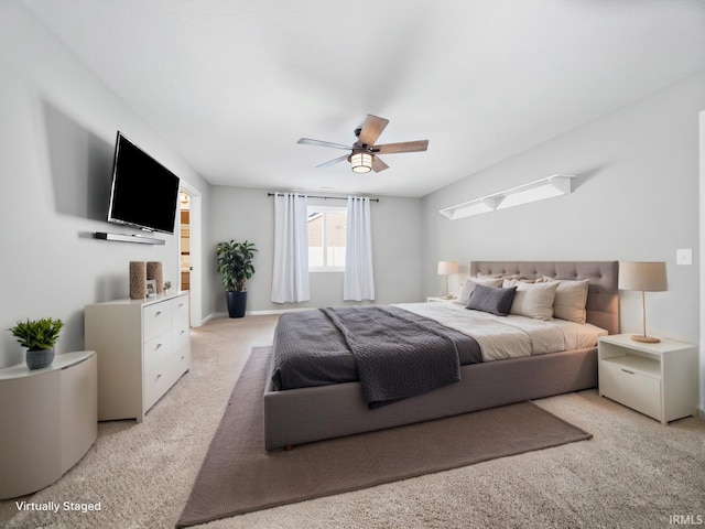 bedroom featuring light colored carpet and ceiling fan