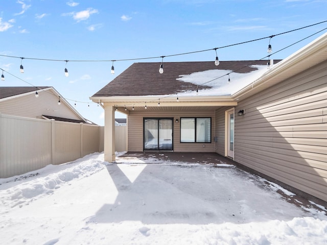 snow covered patio with fence