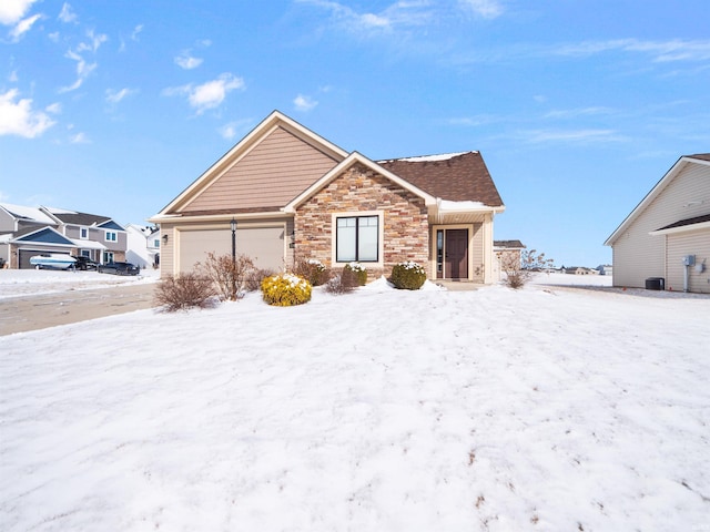 view of front facade with an attached garage and stone siding