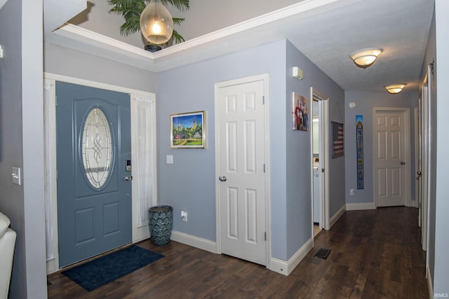 foyer with wood finished floors, visible vents, and baseboards