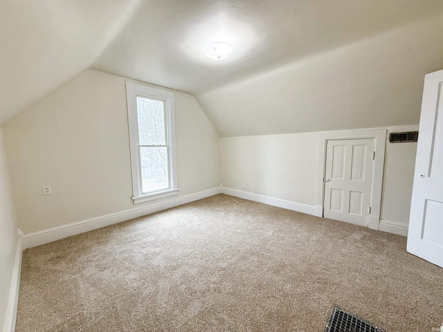 bonus room with vaulted ceiling, carpet, visible vents, and baseboards