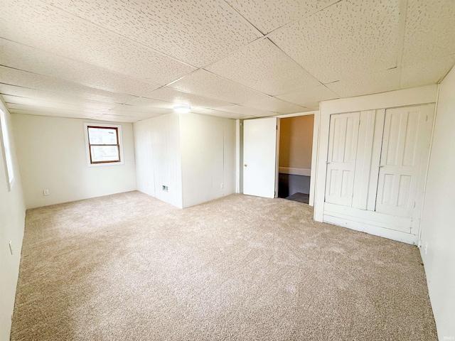 interior space featuring carpet floors and a paneled ceiling