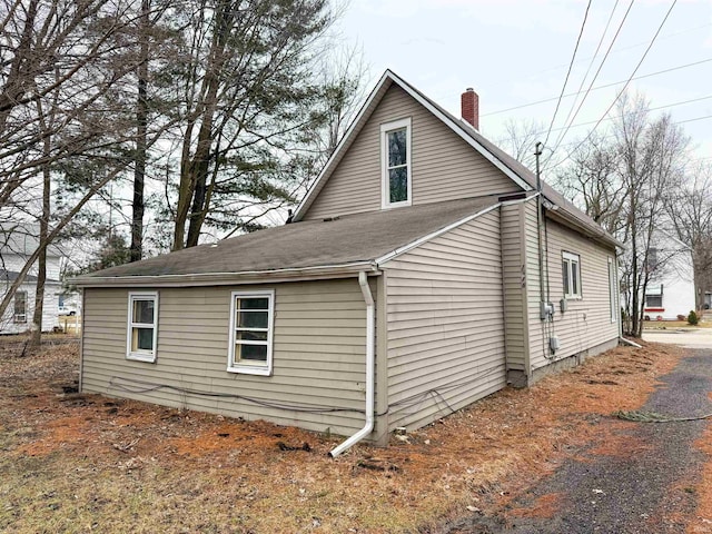 view of property exterior with a chimney