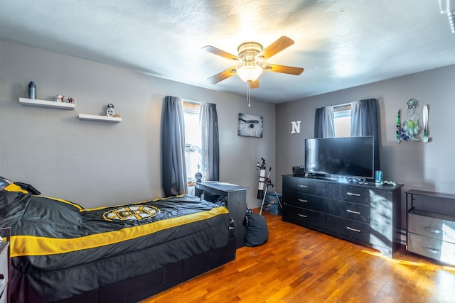 bedroom featuring ceiling fan and wood finished floors