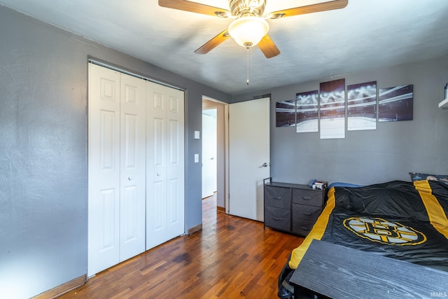 bedroom with ceiling fan, a closet, baseboards, and wood finished floors