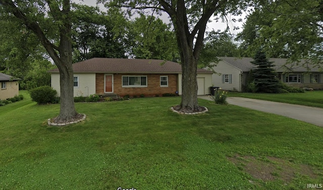 ranch-style house featuring a garage, concrete driveway, a front lawn, and brick siding