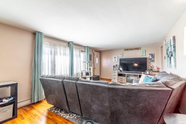 living room featuring light wood-style floors and a baseboard heating unit