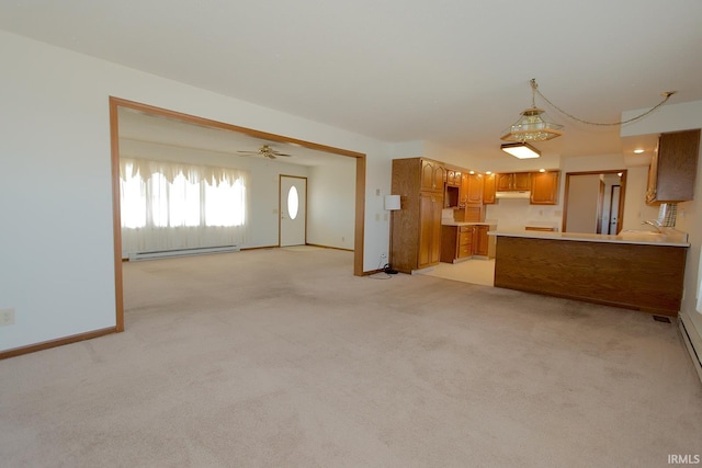 unfurnished living room featuring a baseboard heating unit, ceiling fan, baseboards, and light colored carpet