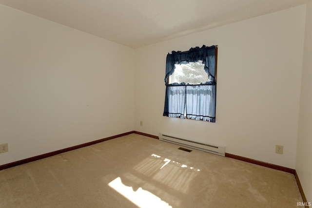 carpeted spare room with a baseboard heating unit and baseboards