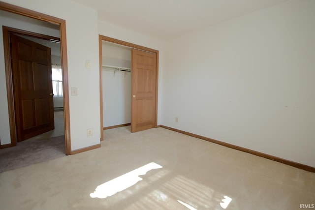 unfurnished bedroom with light carpet, baseboards, and a closet