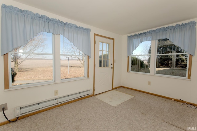 entryway featuring a baseboard heating unit, carpet flooring, and baseboards