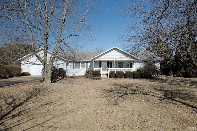 ranch-style home featuring driveway, covered porch, and a garage