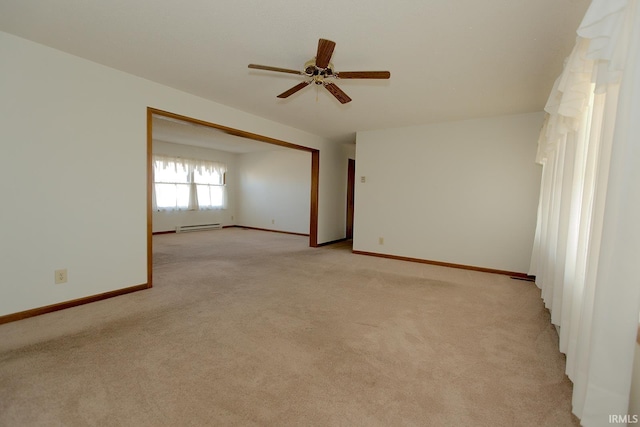 unfurnished room with baseboards, baseboard heating, a ceiling fan, and light colored carpet