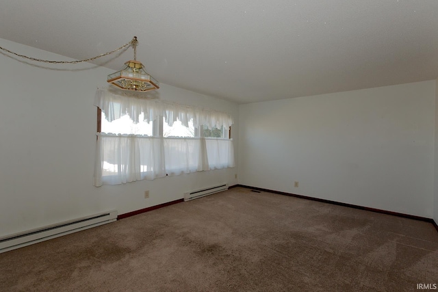 empty room featuring a baseboard heating unit, carpet flooring, and baseboards