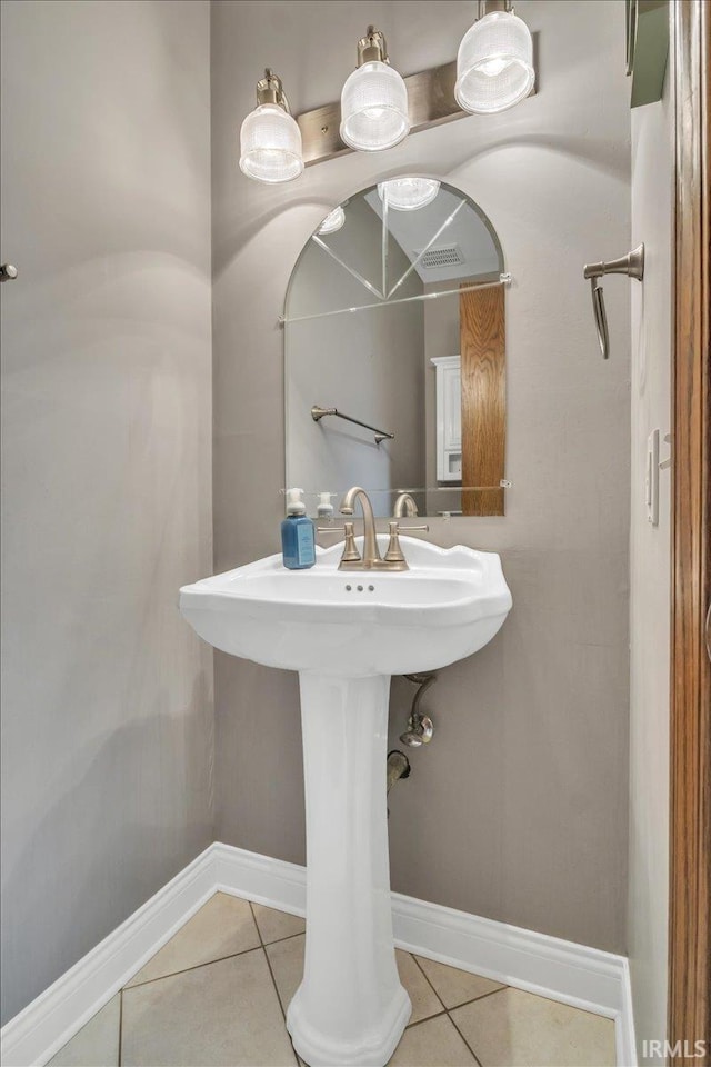 bathroom with tile patterned flooring, visible vents, and baseboards