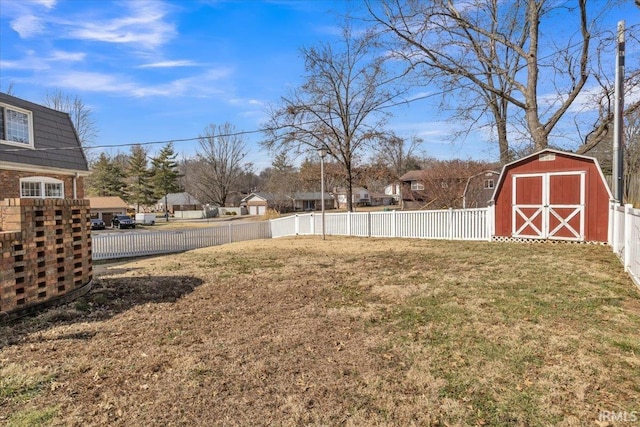 view of yard with a fenced backyard, an outdoor structure, and a shed