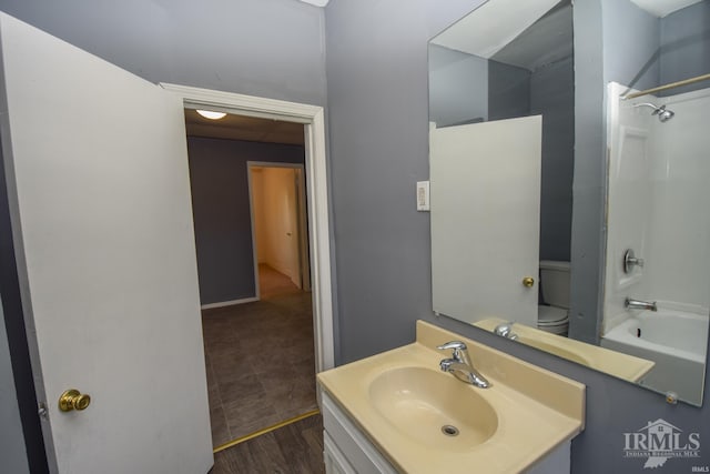 bathroom with toilet, bathtub / shower combination, wood finished floors, and vanity