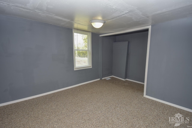 carpeted spare room with baseboards