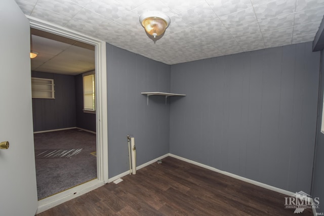 spare room with wood finished floors and baseboards