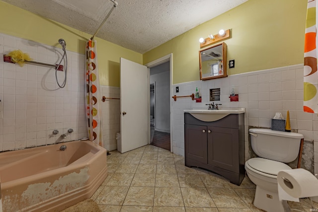 bathroom with a textured ceiling, tile patterned flooring, tile walls, vanity, and shower / tub combo with curtain