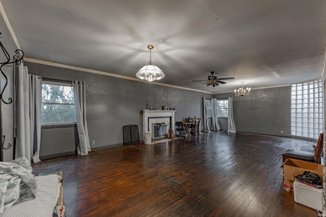 unfurnished living room with a fireplace with flush hearth, a healthy amount of sunlight, and hardwood / wood-style flooring