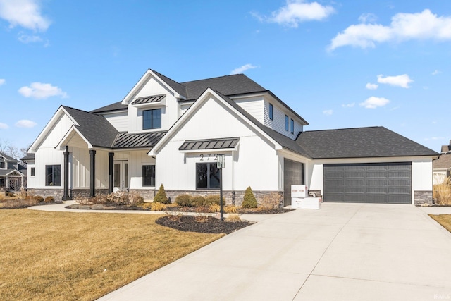 modern farmhouse with an attached garage, a front yard, a standing seam roof, metal roof, and stone siding