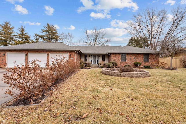 single story home with a garage, fence, a front lawn, and brick siding