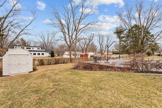 view of yard featuring a storage shed and an outbuilding