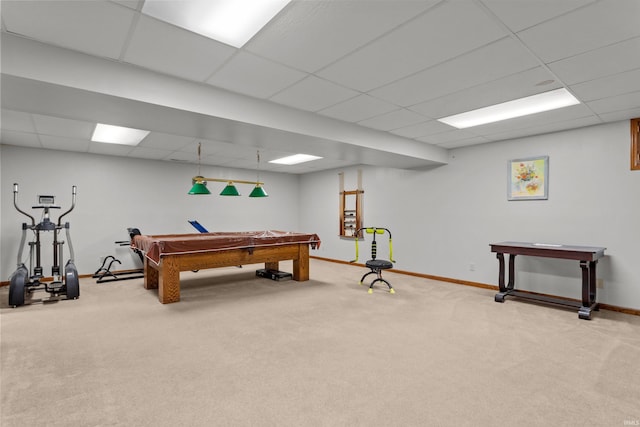 rec room with baseboards, a drop ceiling, and carpet flooring