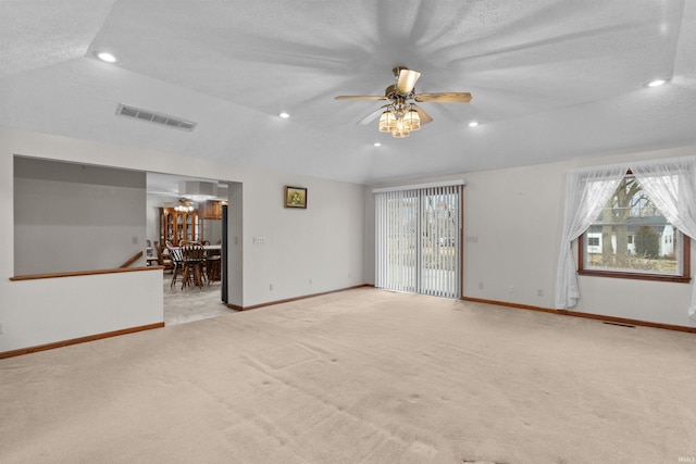 unfurnished room featuring lofted ceiling, visible vents, baseboards, and recessed lighting