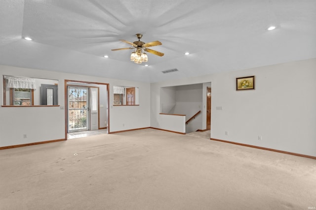 unfurnished living room with recessed lighting, visible vents, baseboards, and light colored carpet