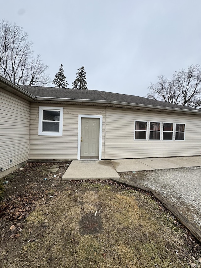 view of exterior entry with a patio area