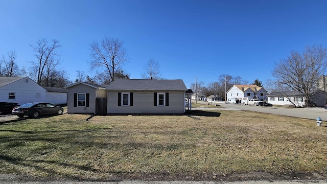 view of front facade featuring a residential view and a front lawn