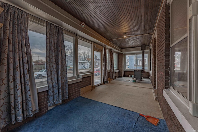 unfurnished sunroom featuring wood ceiling