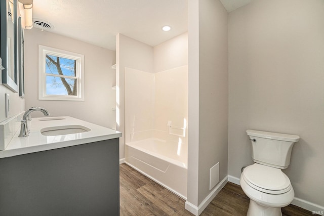 full bathroom featuring visible vents, a sink, toilet, and wood finished floors