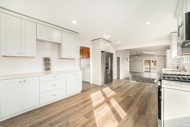 kitchen with recessed lighting, a ceiling fan, light wood-style floors, open floor plan, and appliances with stainless steel finishes