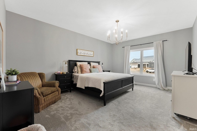 carpeted bedroom featuring baseboards and an inviting chandelier