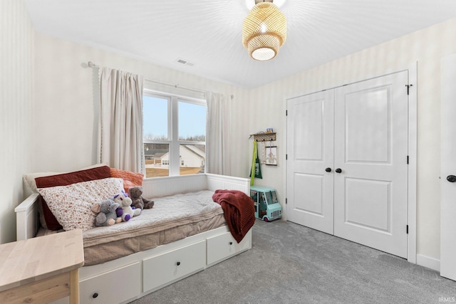 bedroom with a closet, carpet, and visible vents