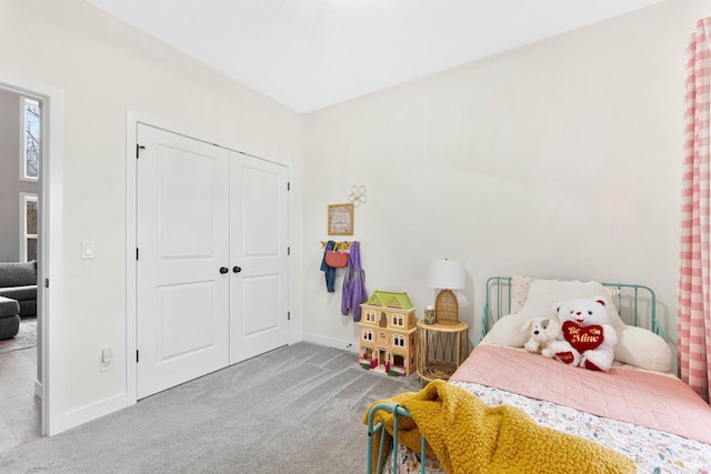 bedroom with carpet floors, a closet, and baseboards