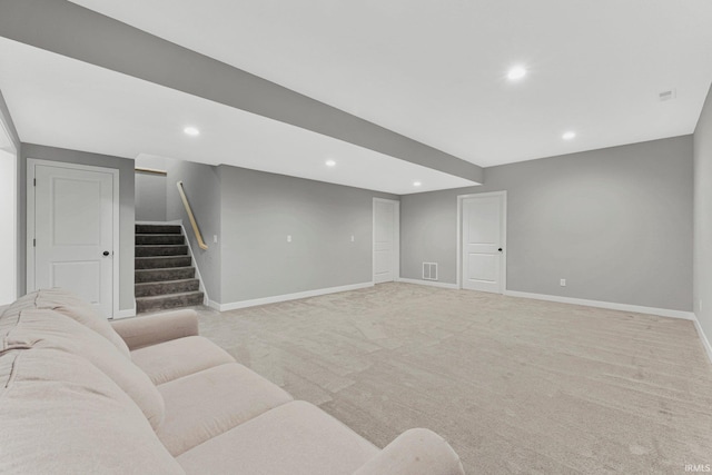 carpeted living room featuring baseboards, visible vents, stairway, and recessed lighting