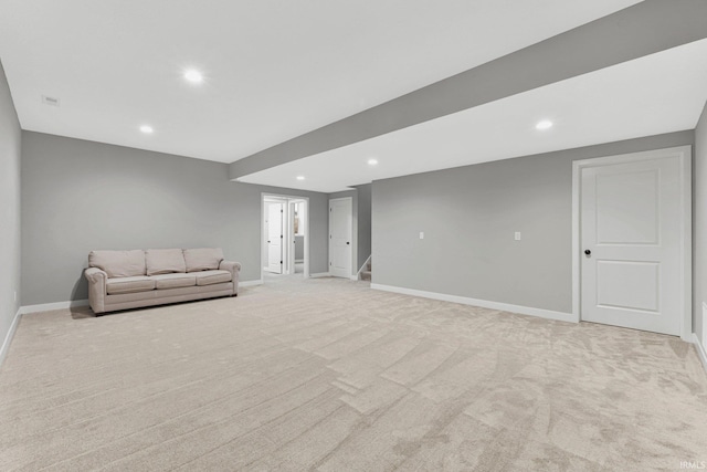 unfurnished living room with recessed lighting, light colored carpet, stairway, and baseboards