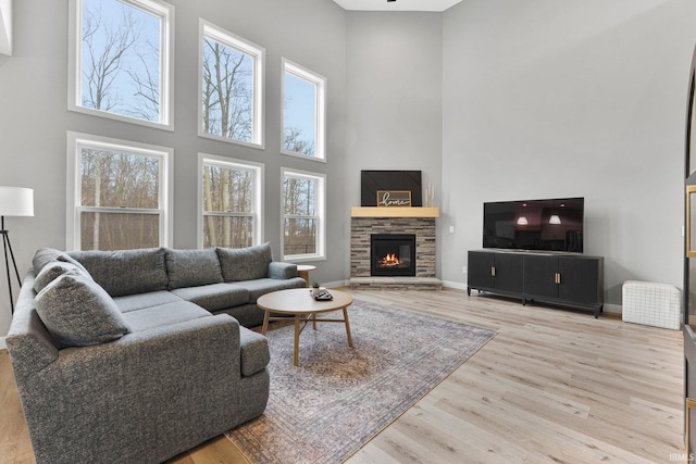 living area featuring wood finished floors, a wealth of natural light, and baseboards