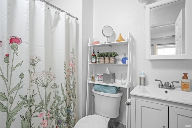 bathroom with a shower with curtain, vanity, and toilet