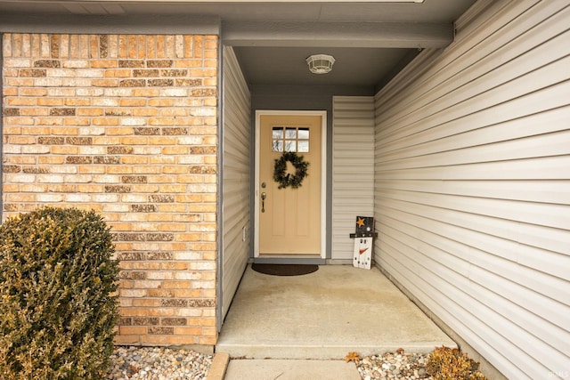 property entrance featuring brick siding