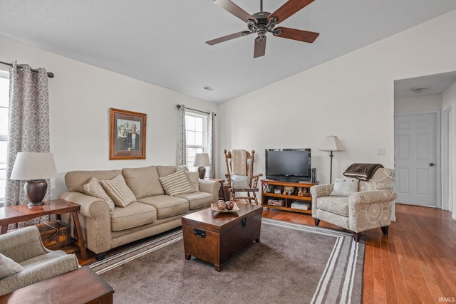 living area with a ceiling fan, vaulted ceiling, and wood finished floors