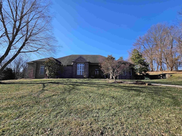 single story home with brick siding and a front lawn