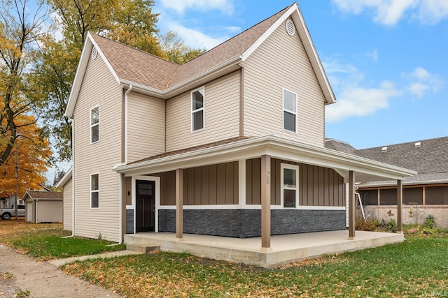 view of home's exterior featuring board and batten siding, stone siding, and roof with shingles