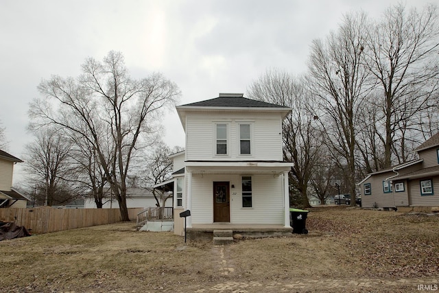 view of front facade with covered porch and fence