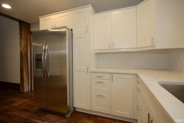 kitchen with white cabinets, dark wood-style floors, and stainless steel refrigerator with ice dispenser